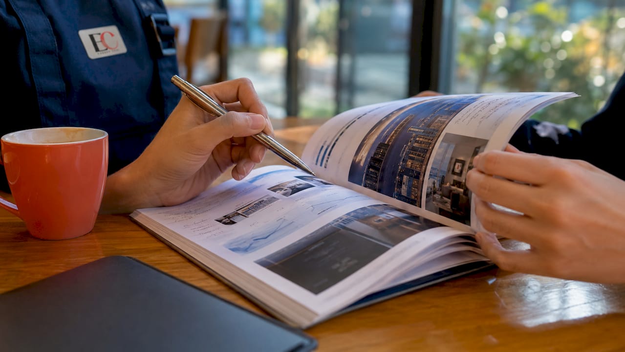 Buying property in Singapore: 2026 complete guide 2 Hands reviewing property financing guide