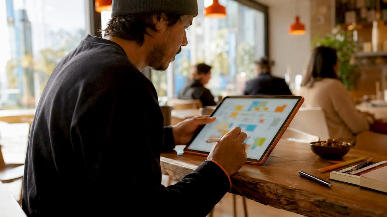 Hands using stylus on digital whiteboard tablet