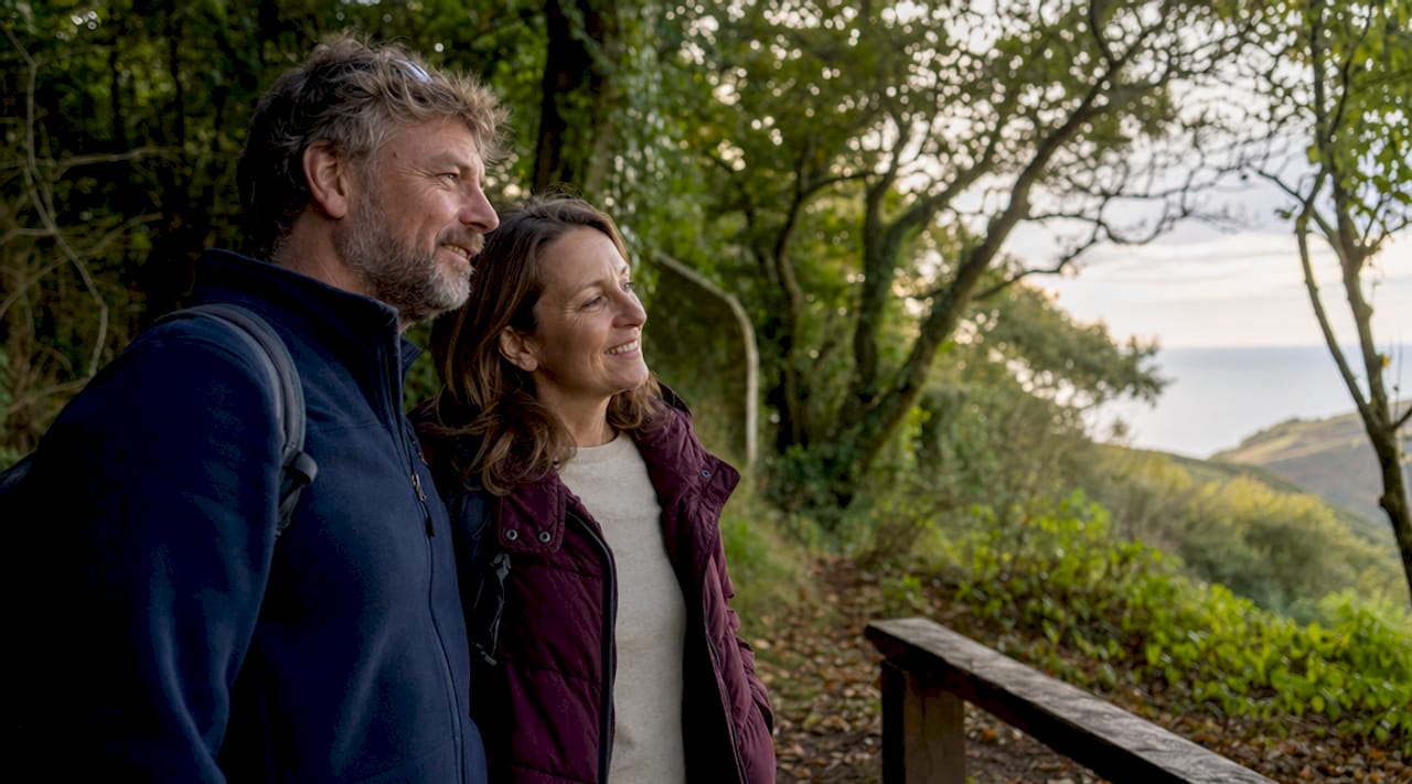 Couple walking Devon coastal path outdoors