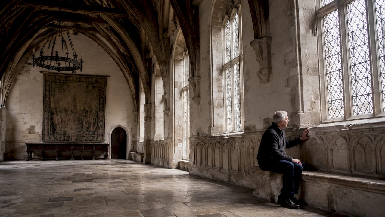 Interior of The Great Hall with visitor admiring medieval details