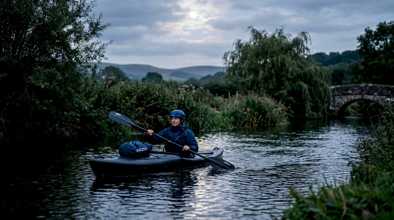 Kayaker on Devon river at dawn