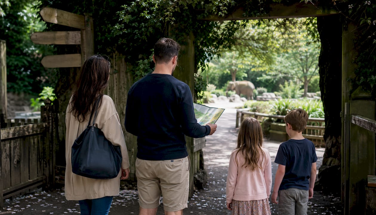 Family entering Dartmoor Zoo Park woodland entrance