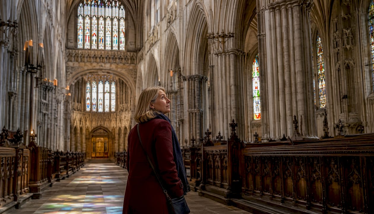 Visitor admiring Exeter Cathedral nave interior
