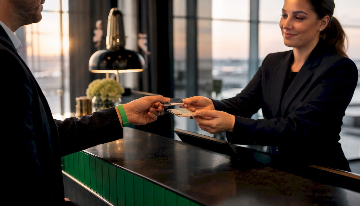 Hands exchanging card at luxury rental desk