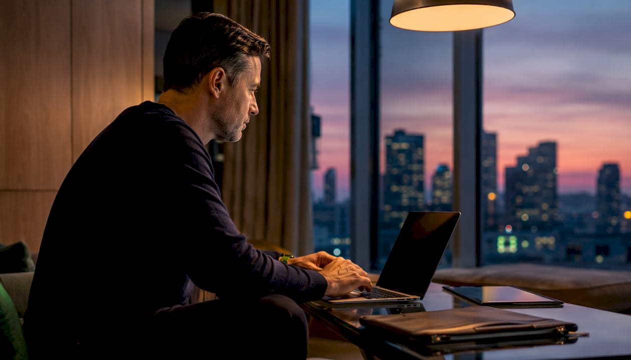 Man browsing luxury airport transfer options on laptop