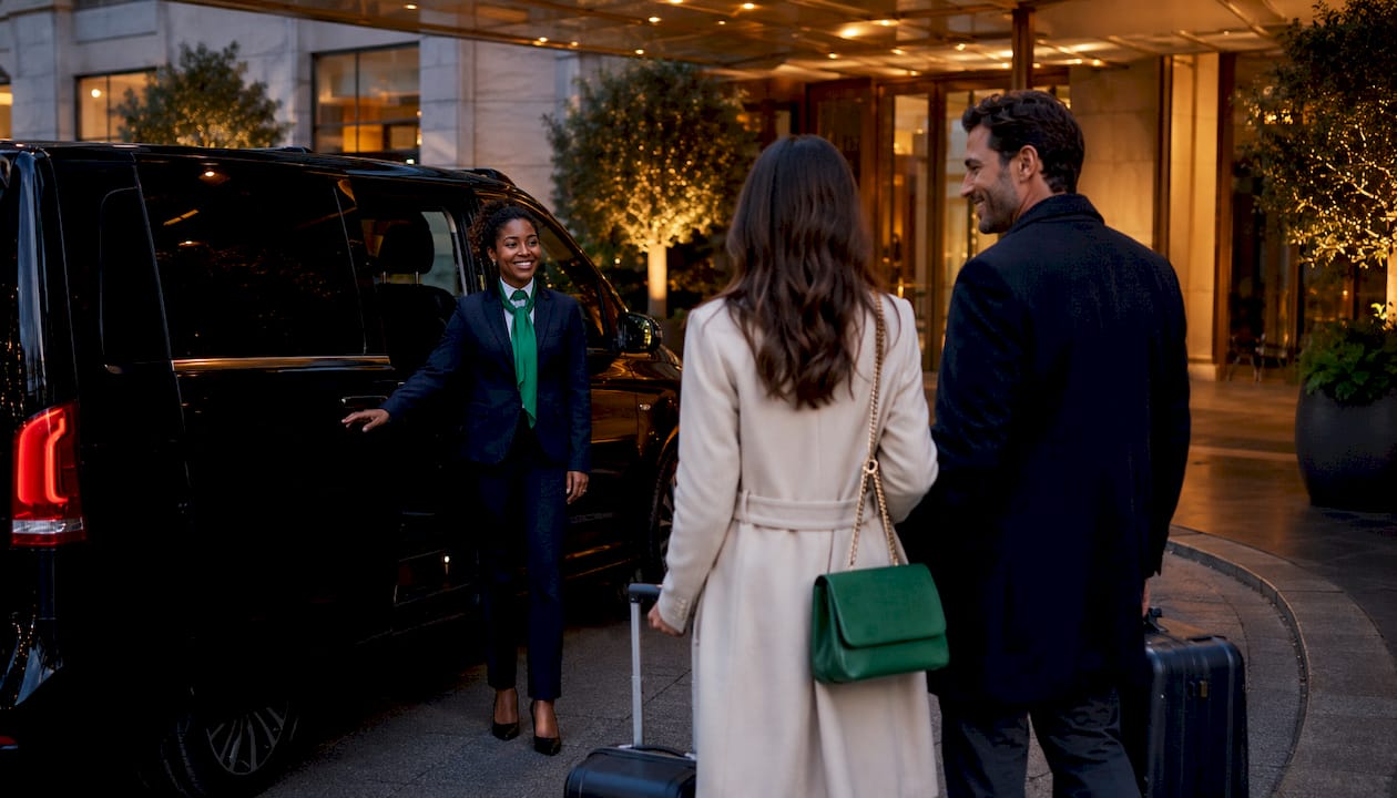 Luxury airport transfer vehicle with chauffeur and passengers