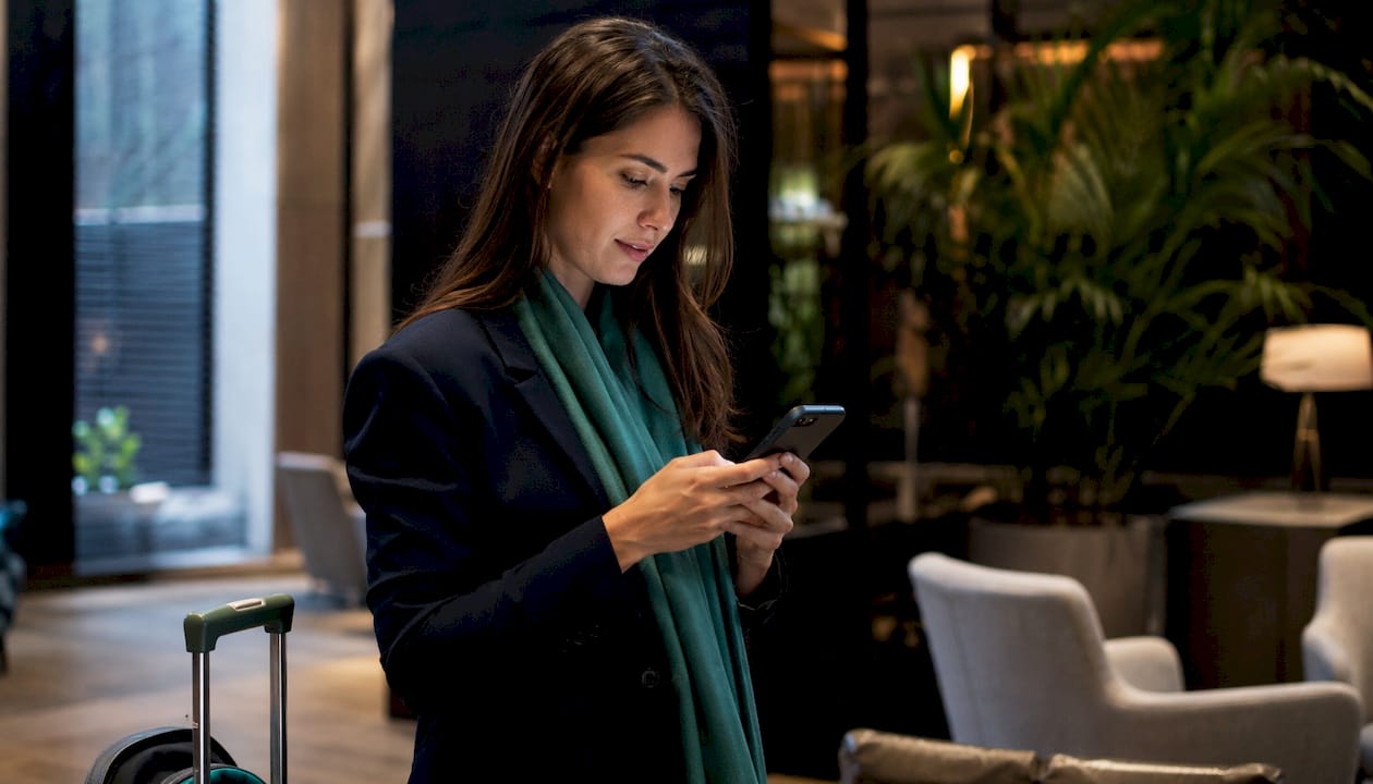 Traveler checking flight status on smartphone