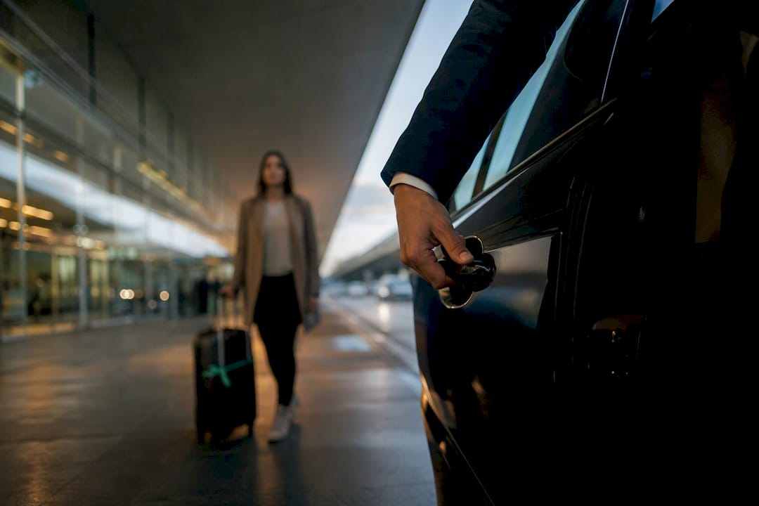Chauffeur opening vehicle door at Nice airport
