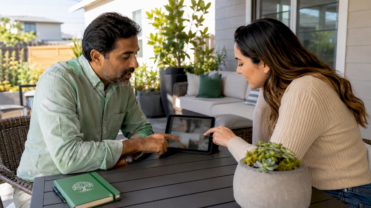 Inspector explaining home inspection findings to buyer