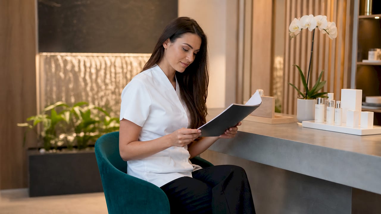 Beauty professional reviewing client intake form