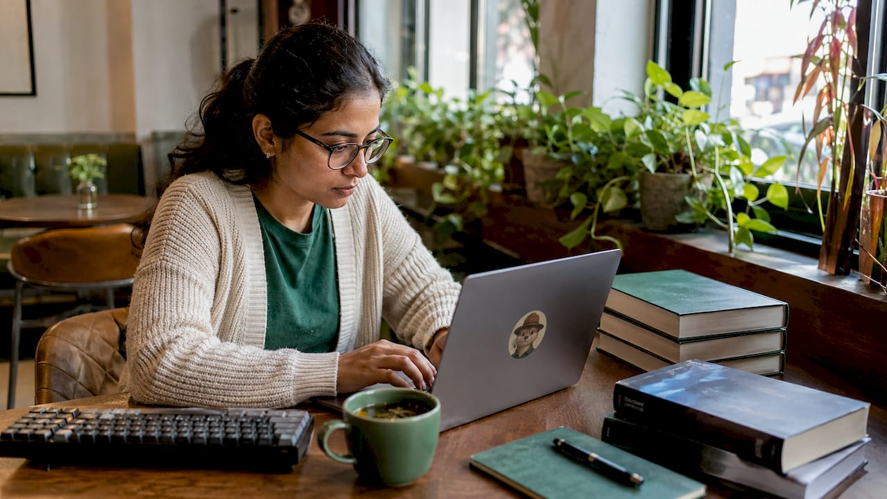 Woman working on SSL certificate monitoring at desk