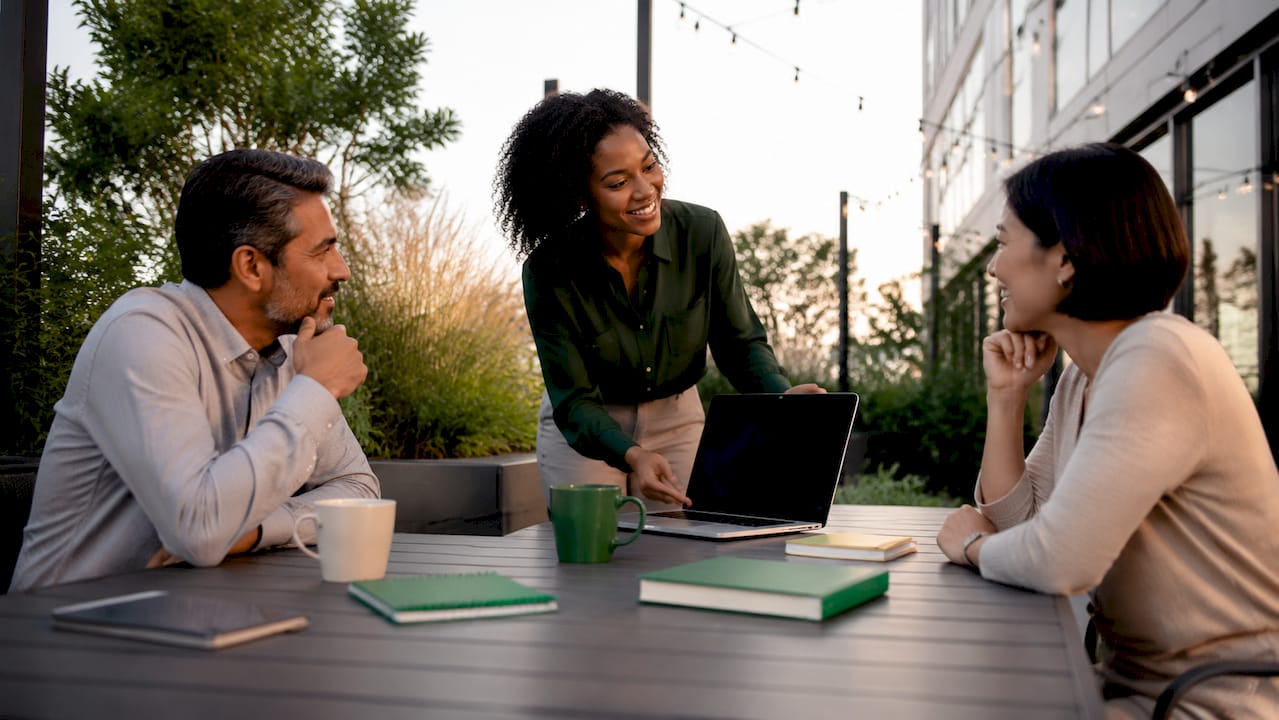 Professionals discussing franchise marketing data in office