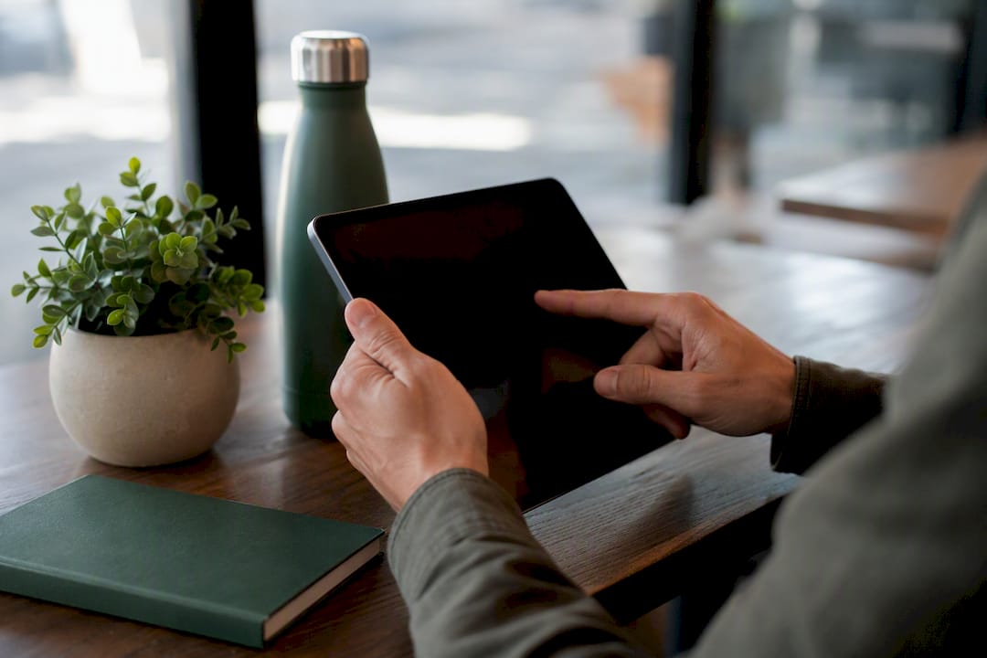 Hands interacting with tablet for ad targeting