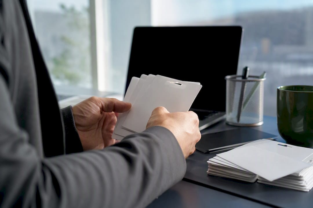 Hands verifying buyer credentials with documents