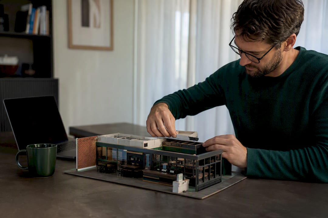 Entrepreneur inspecting miniature franchise model