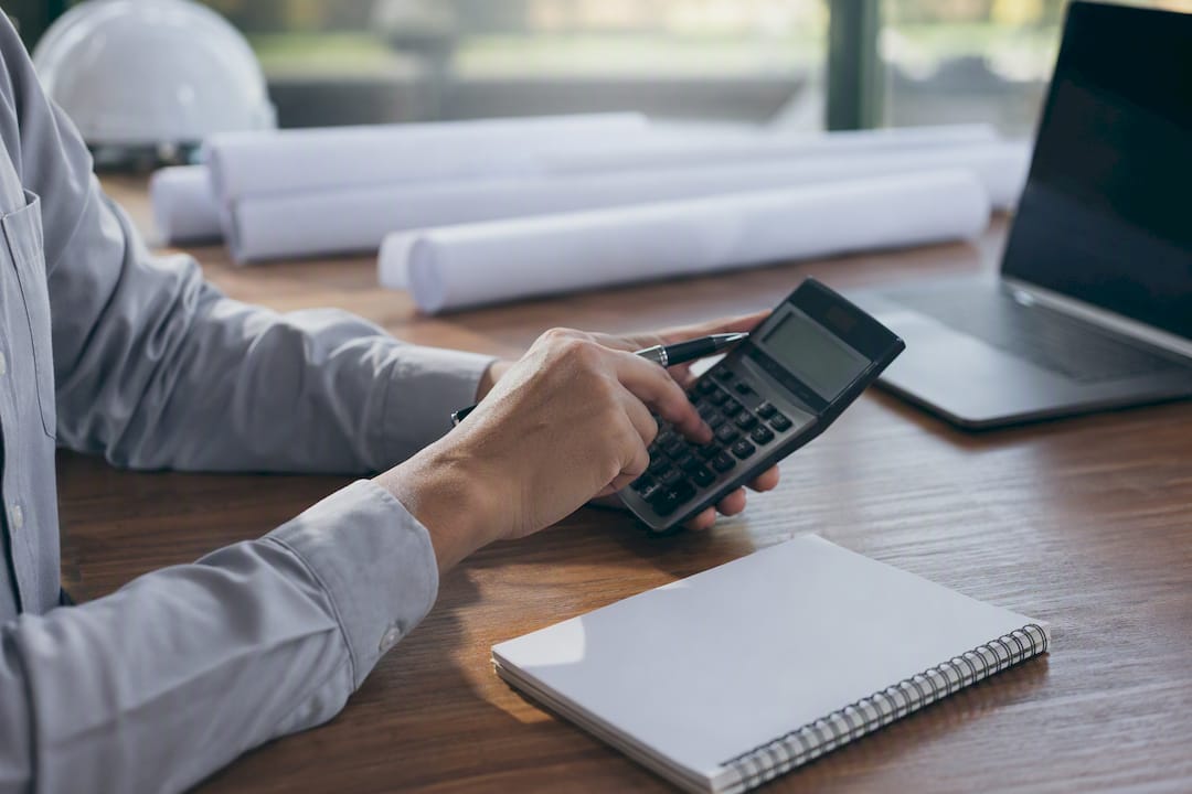 Hands calculating franchise investment details