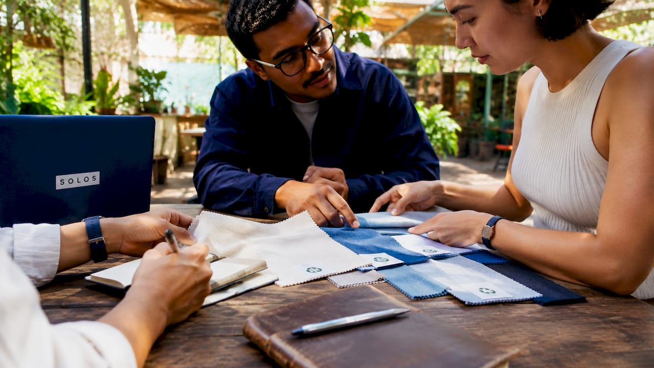 Hands reviewing eco-friendly textile certification labels