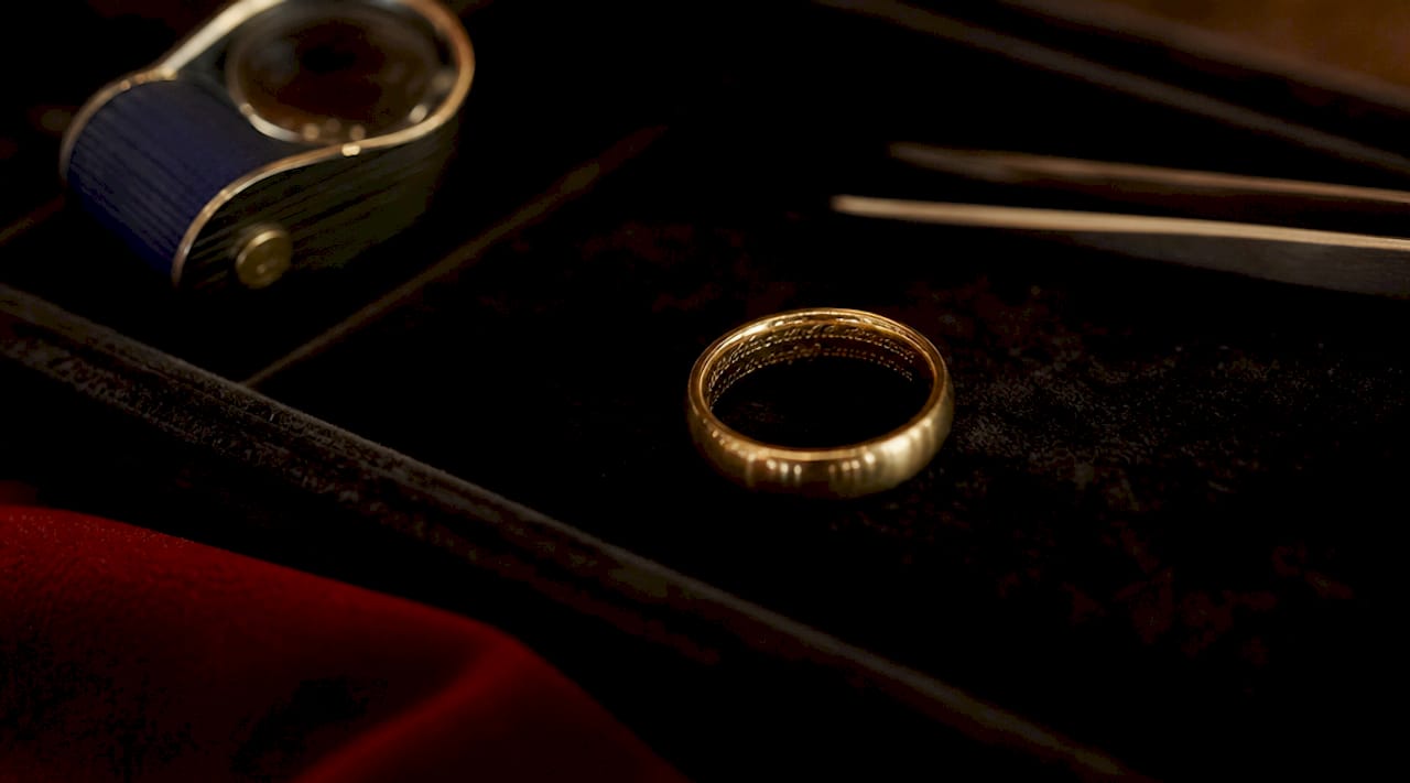 Close-up of engraved silver ring on linen fabric