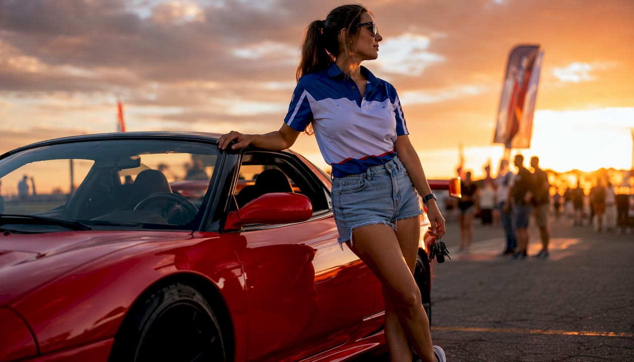 Female enthusiast with manual sports car