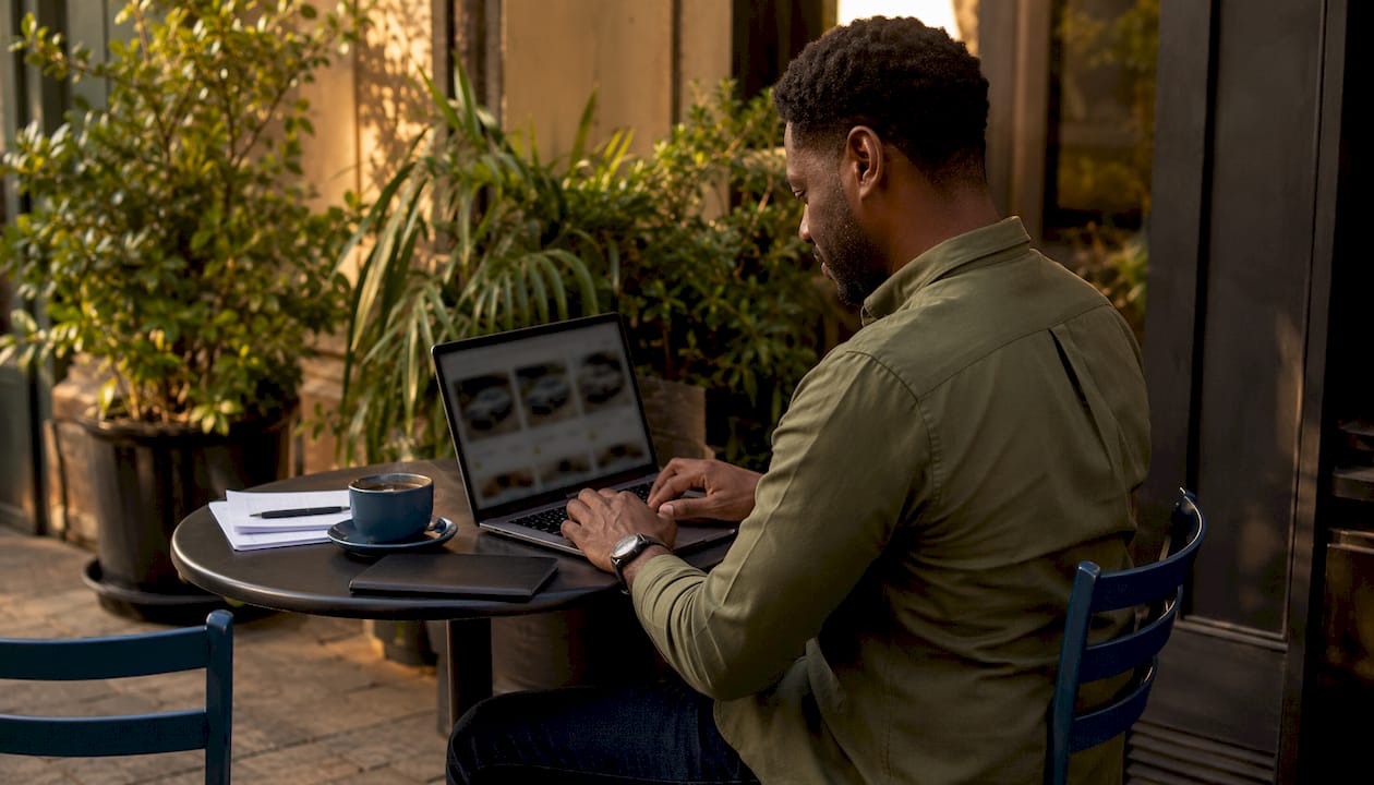 Man researching used Mini Cooper listings online