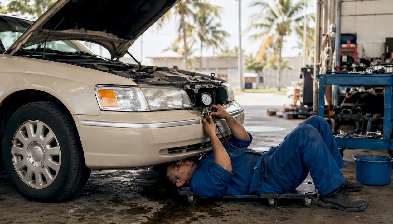 Mechanic checking cooling system on Town Car