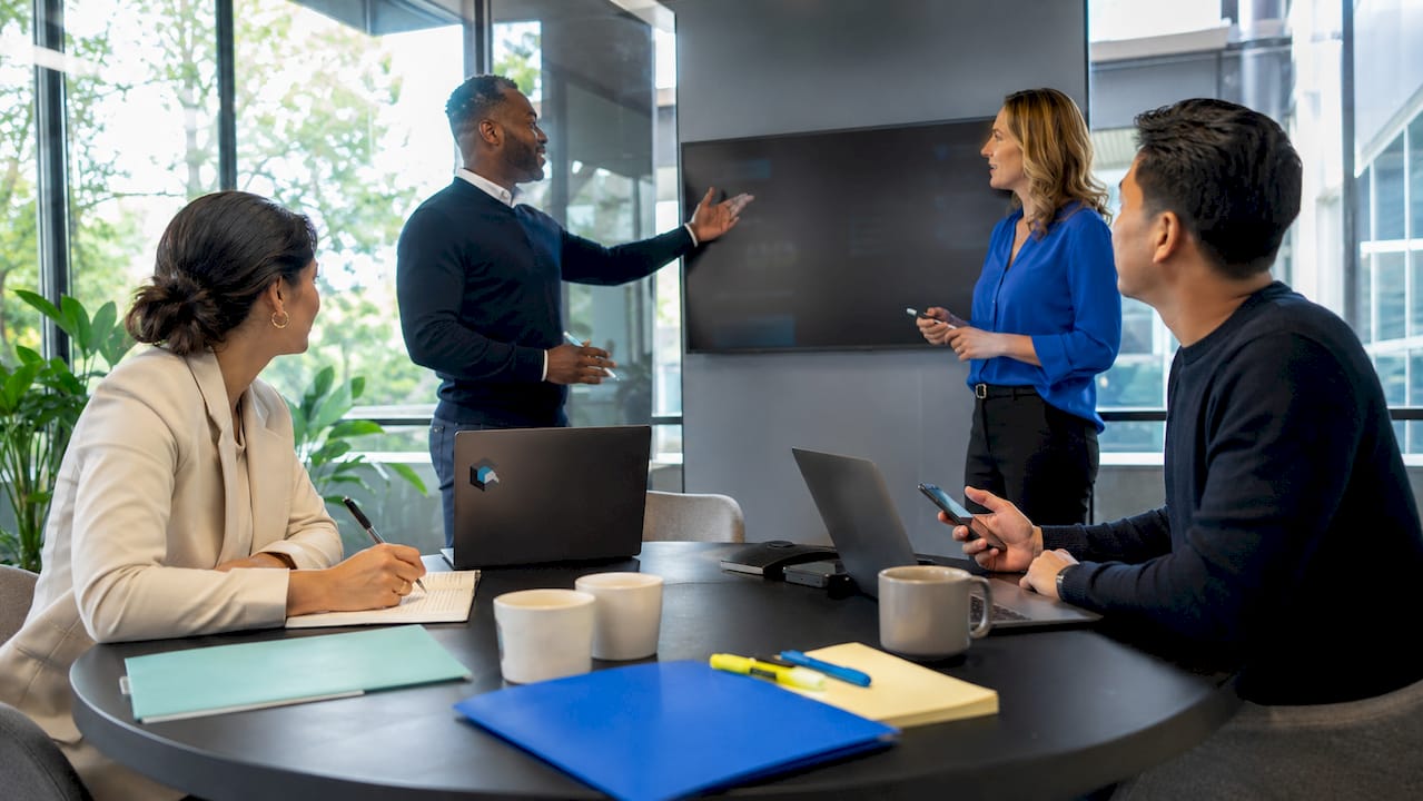 Inside sales team collaborating in meeting room