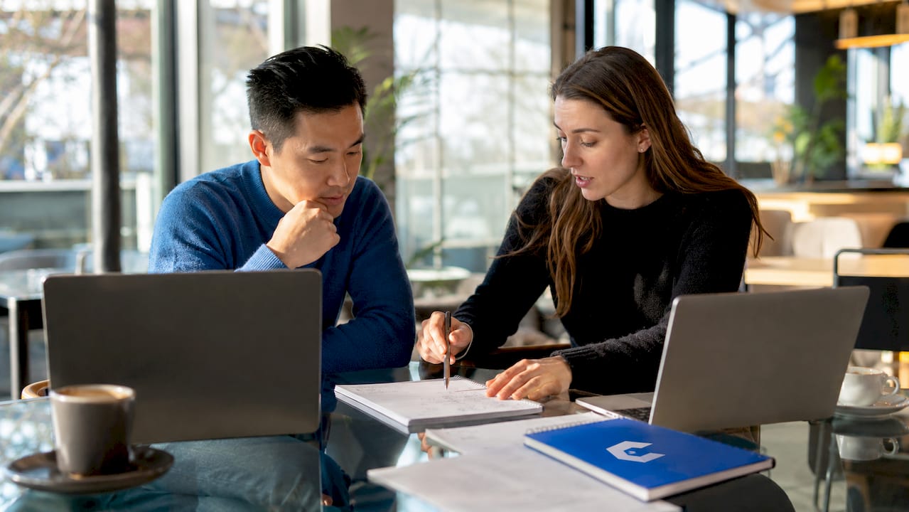 Two professionals discussing intake session notes