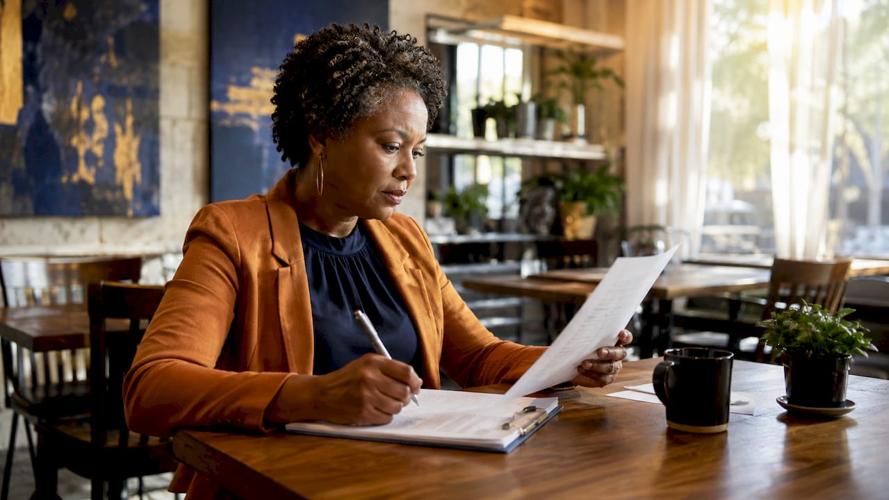 Insurance claims specialist reviewing documents in office