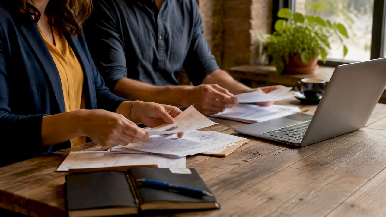 Hands organizing lemon law filing documents