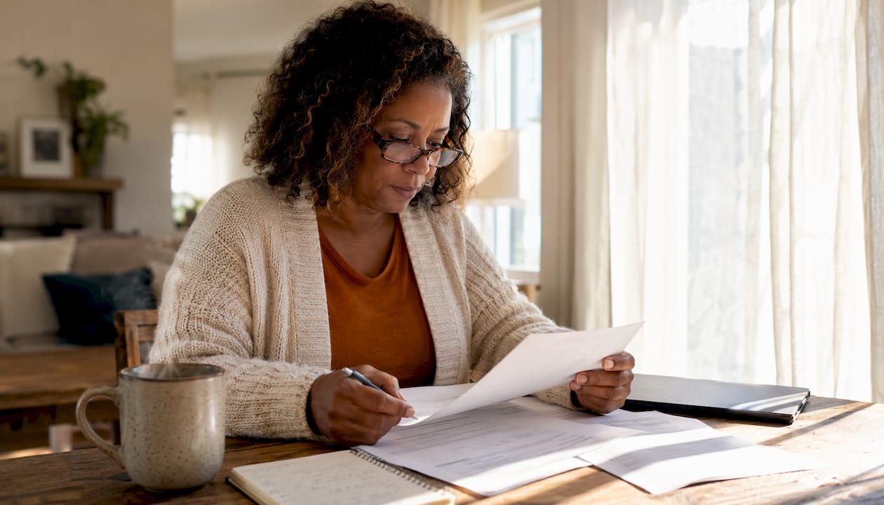 Louisiana homeowner reviewing insurance documents at table