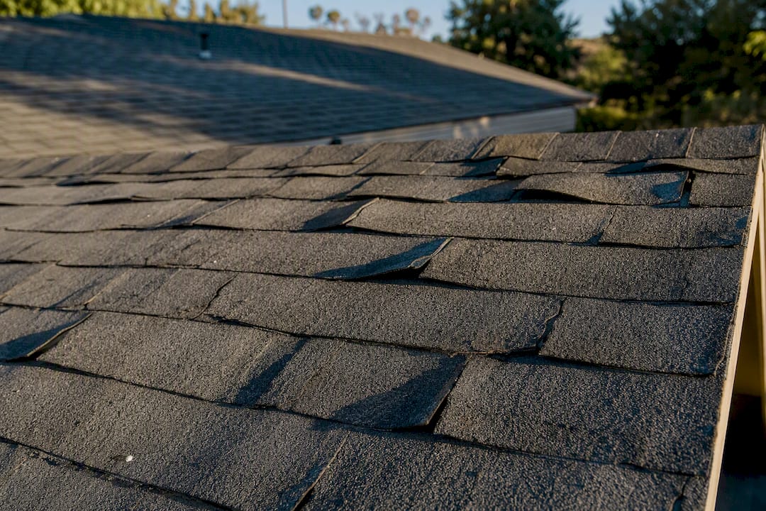 Racked shingles with wind damage lifting sections