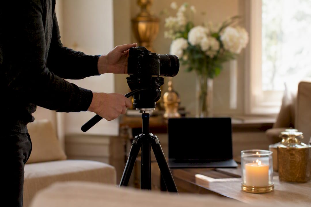 Hands adjusting webcam for online memorial