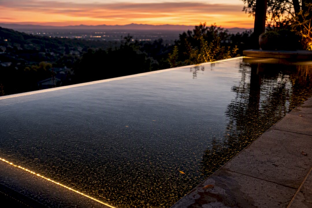 Dark finish infinity pool water with LED edge lighting