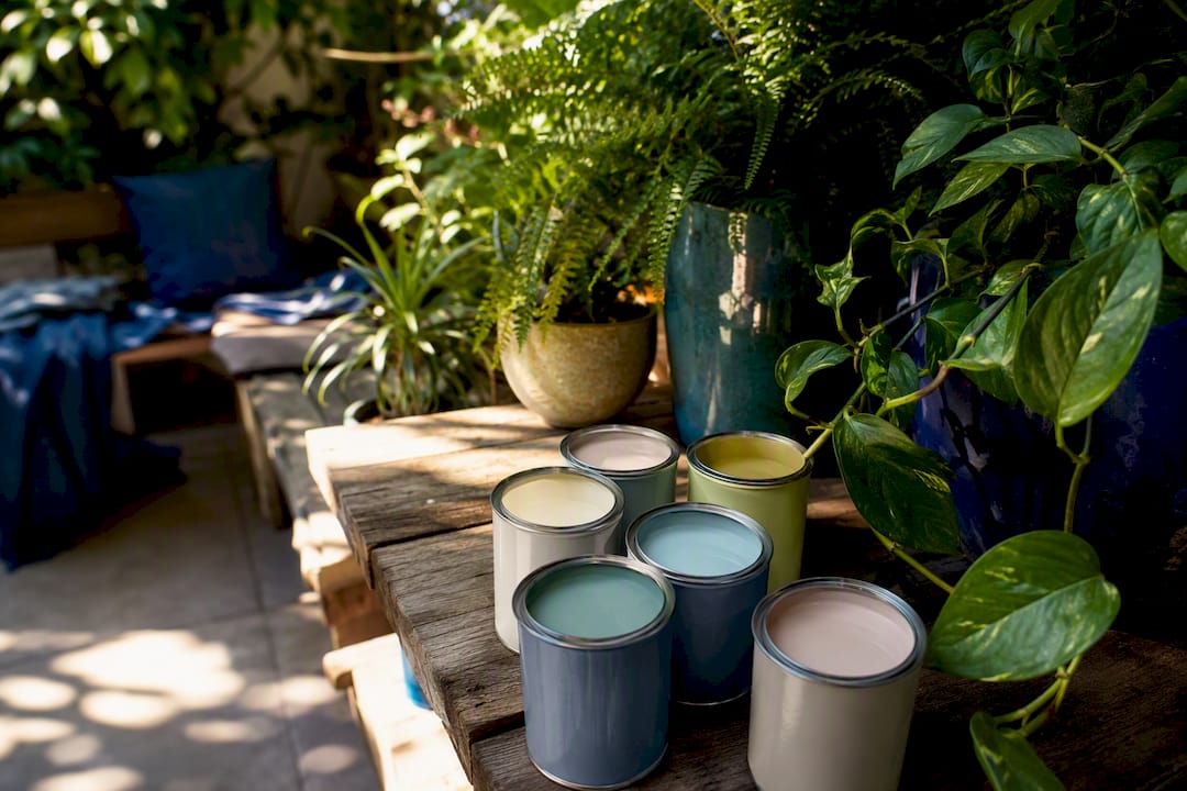 Paint cans and indoor plants symbolizing eco friendliness