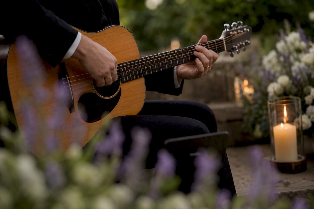 Hands playing acoustic guitar in memorial chapel