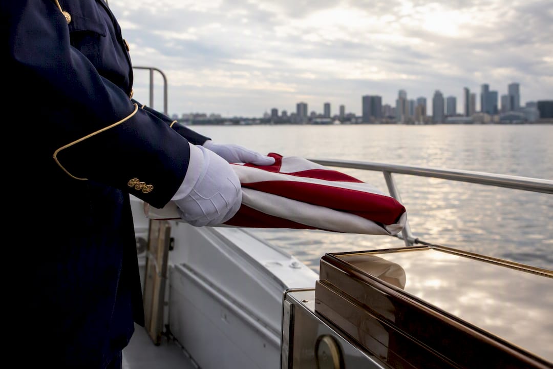 Hands folding American flag during burial ceremony