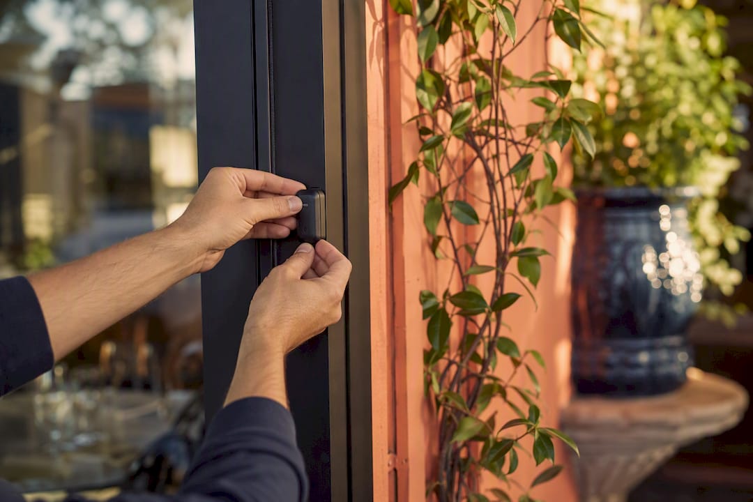 Hands installing marketing attribution sensor device