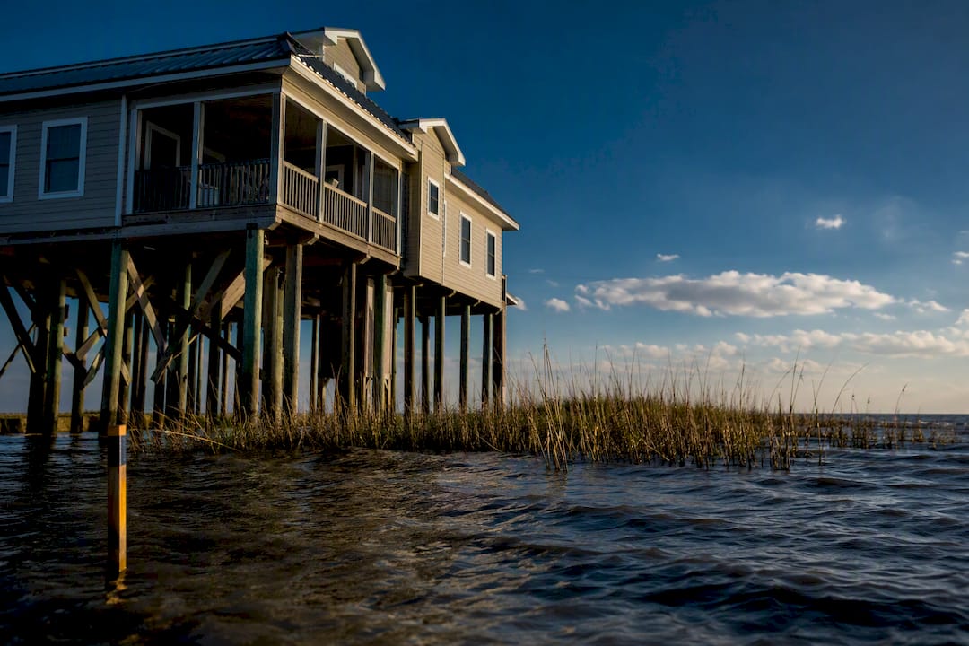 Elevated Louisiana home beside flood-prone shoreline