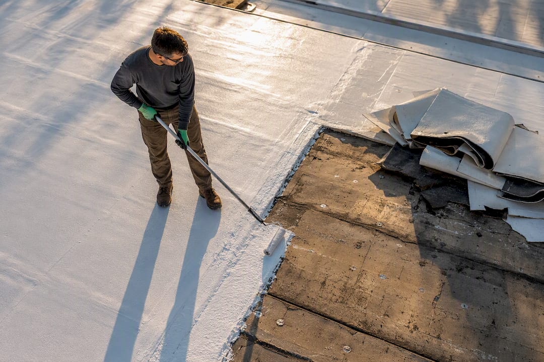 Roof coating beside partially opened roof assembly