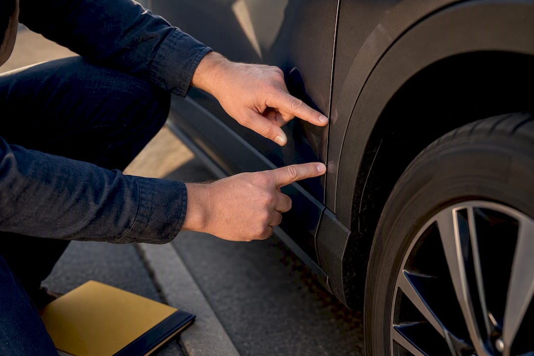 Owner inspecting defect on leased vehicle