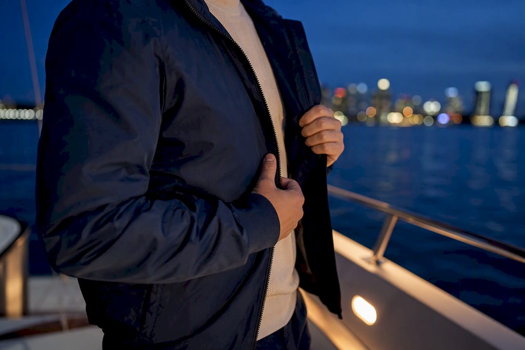 Guest fastening jacket on evening sail