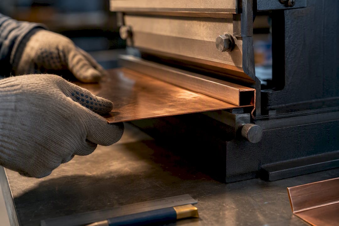 Fabricator precisely forming a copper panel seam