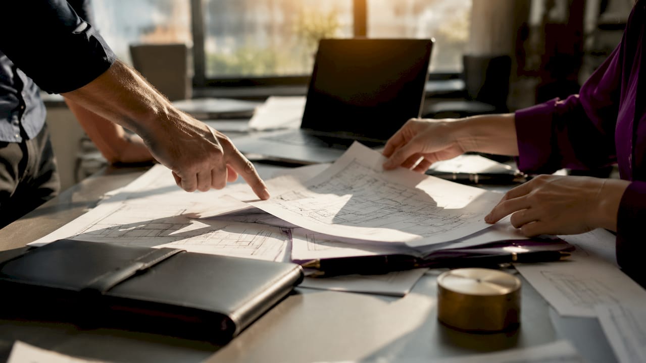 Hands sorting commercial contract documents