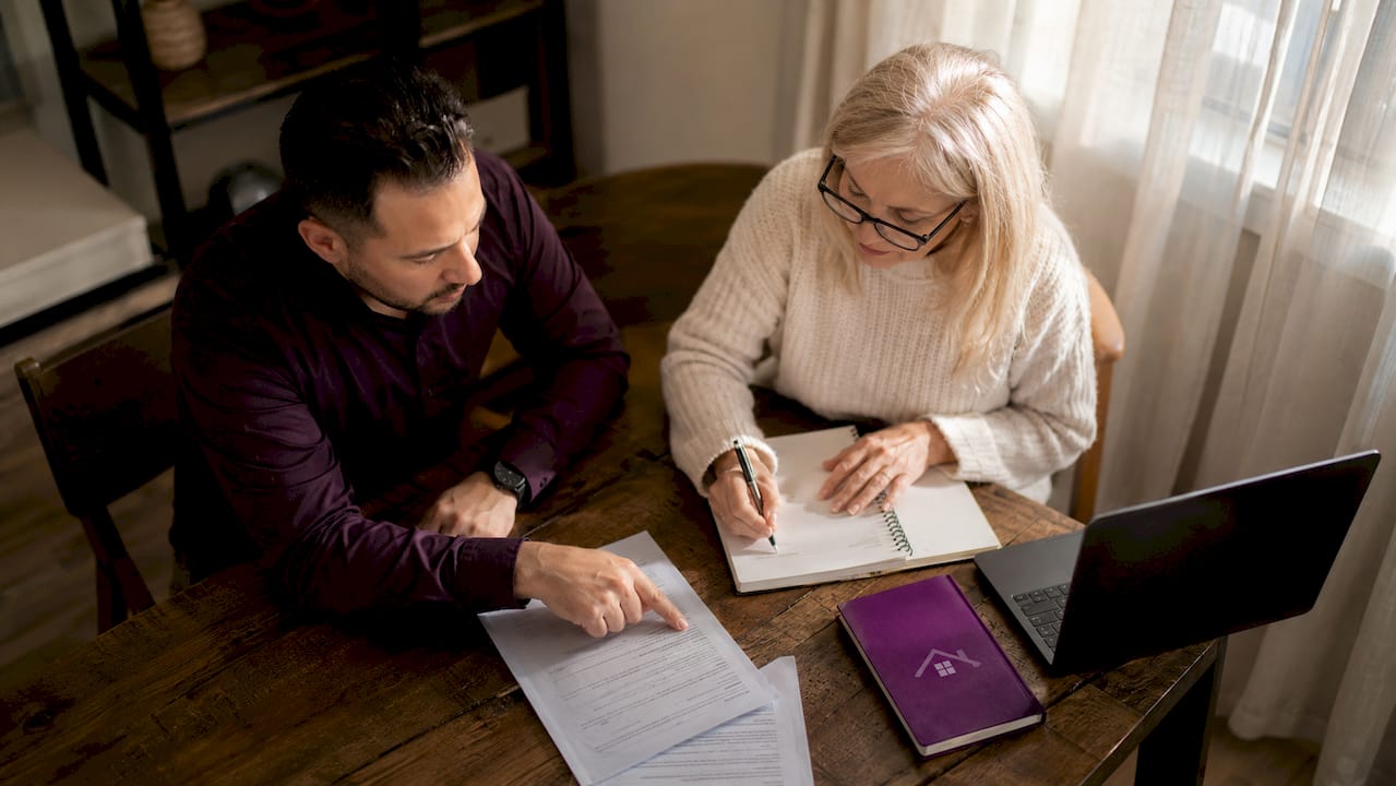 Contractor and homeowner discussing contract clauses