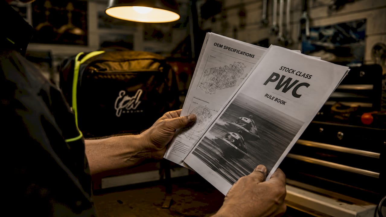 Close-up of hands holding PWC rules and specs booklets