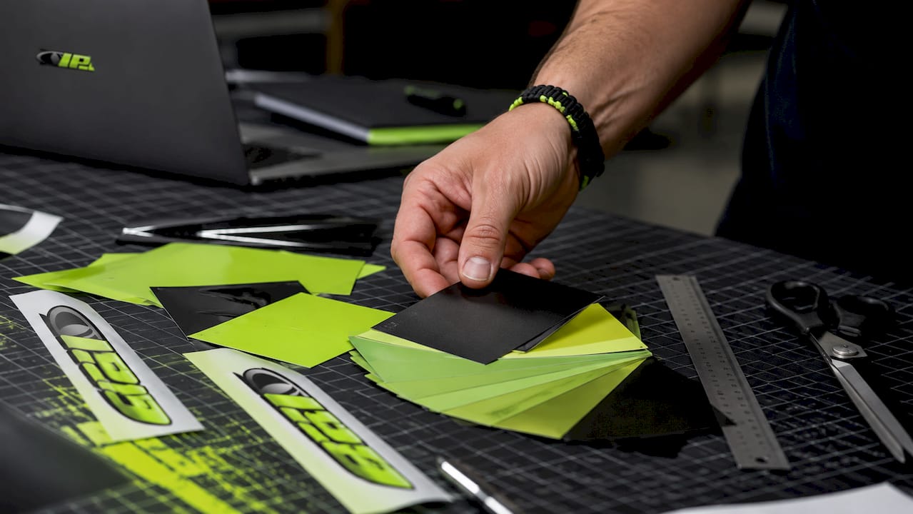Hands arranging fleet branding color and logo samples