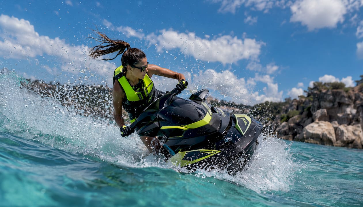 Female rider shifting weight in jet ski spin