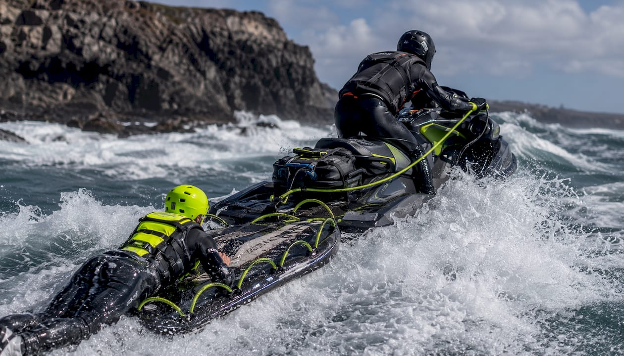 PWC driver rescuing surfer after wipeout