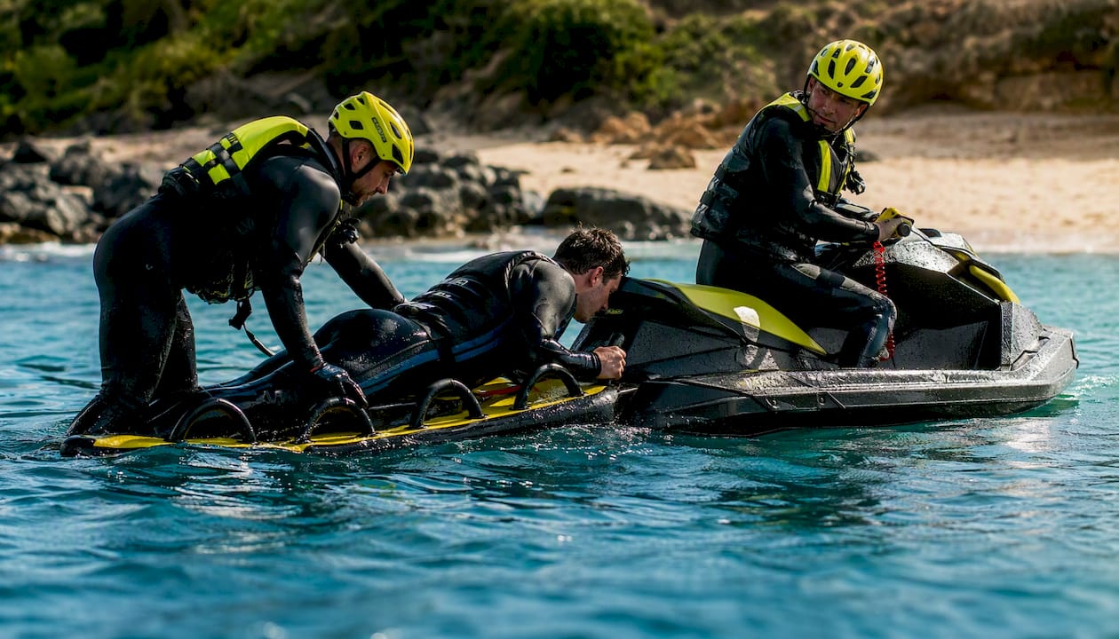 Overhead view of rescue sled patient loading at sea