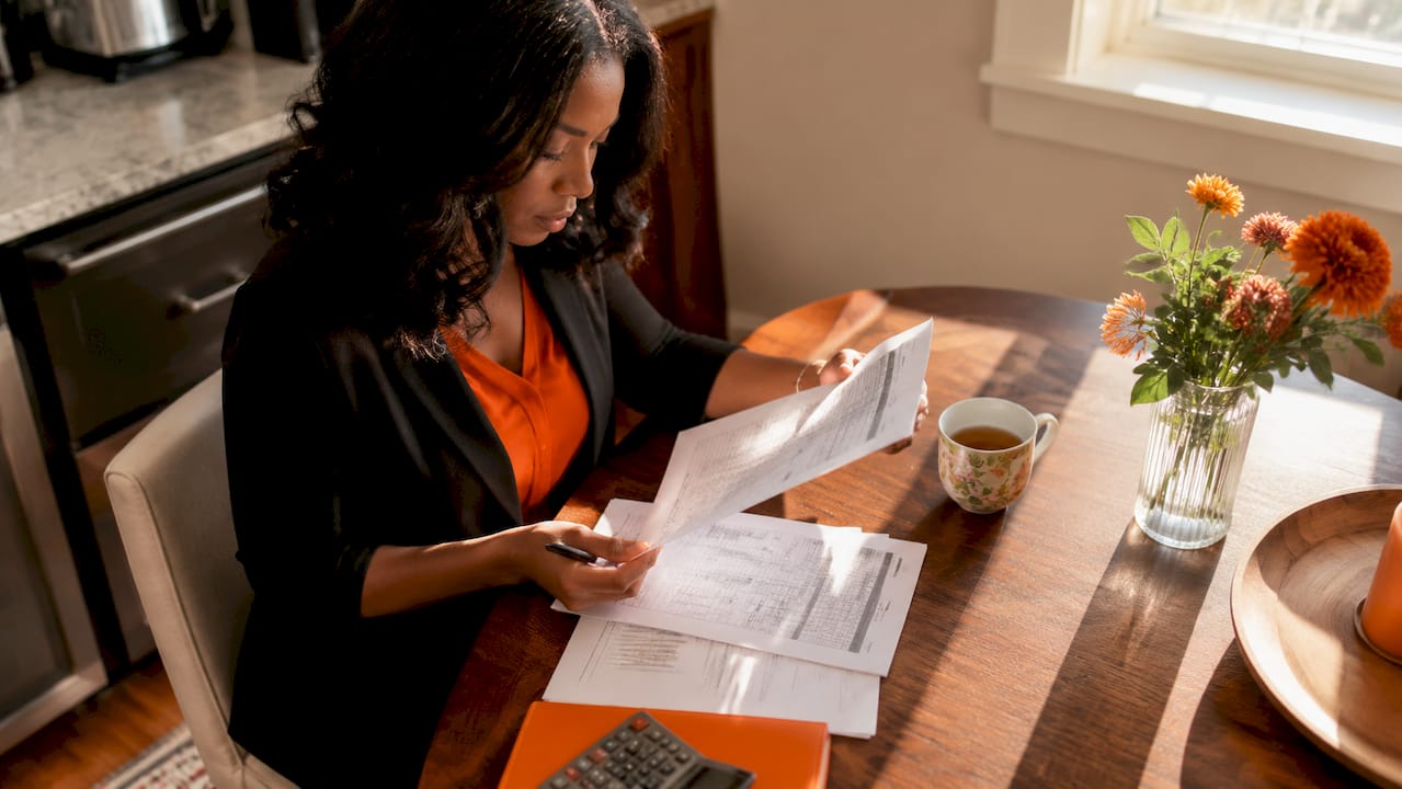 Woman reviewing marketing agency overhead reports